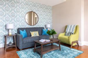 a living room with a couch and a chair at Roami at Hibernia Tower in New Orleans