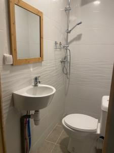 a bathroom with a sink and a toilet and a mirror at Location chambres chez Zam in Mamoudzou +39 photos