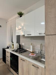 a kitchen with a sink and a stove top oven at level UP -self check in in Osijek