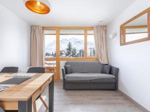 a living room with a couch and a table at Studio Avoriaz, 1 pièce, 4 personnes - FR-1-314-216 in Morzine