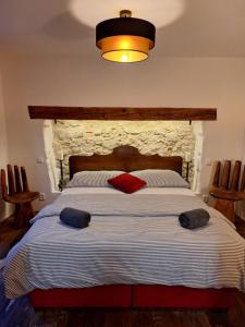 a bedroom with a large bed with red pillows on it at Pension Sebastian in Mikulov