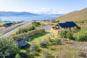 an aerial view of a farm with a road and a house at Beautiful cabin near Grenivík in Grenivík