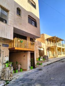 a building with a wooden balcony on a street at The guset house in Kerak