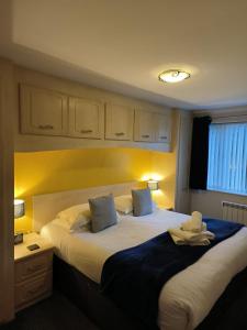 a bedroom with two beds with towels on them at Ghyll Rigg in Bowness-on-Windermere