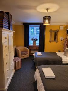 a hotel room with two beds and a window at Luxe rooms in Edinburgh