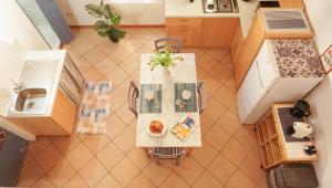 an overhead view of a table and chairs in a kitchen at Saint Mary House in Alghero