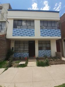 a blue and white building with a door at Inca Wasi in Puno