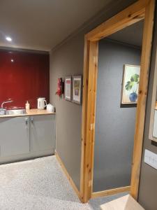 a kitchen with a door open to a counter top at THE MOORINGS in Broadford