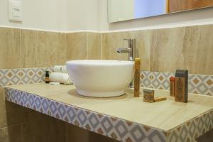 a bathroom with a white sink on a counter at Luna Azul Bacalar in Bacalar