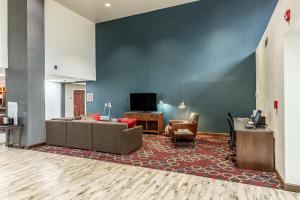 a living room with a couch and a tv at Four Points by Sheraton Greensboro Airport in Greensboro