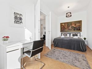 a white bedroom with a bed and a desk at SKY9 Apartments City Center in Vienna