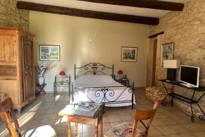 1 dormitorio con 1 cama, mesa y sillas en Maison avec piscine chauffée, jacuzzi et sauna 26p, en Caderousse