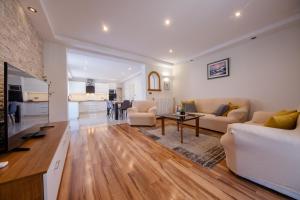 a living room with a couch and a table at Ania Apartment in Rab