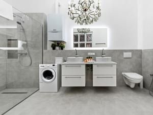 a bathroom with a washing machine and a washer at SKY9 Apartments City Center in Vienna