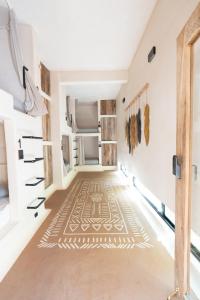 a room with a hallway with a rug on the floor at Secret Beach Hostel in Puerto Escondido