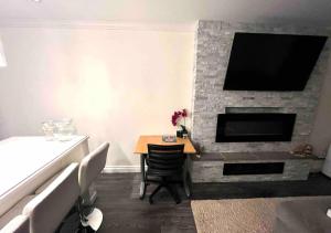 a living room with a table and a fireplace at Ocean Villa -1BDR- King bed- Kitsilano beach w/parking in Vancouver