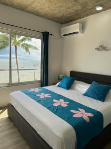 a bedroom with a bed with a view of the beach at Pension Irivai, appartement UO UO 3 chambres vue mer in Uturoa