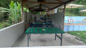 a ping pong table sitting inside of a house at ESPAÇO SHEHERAZADE PISCINA e LAZER in Juquitiba