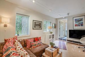 a living room with a couch and a tv at Retro El Sobrante Apartment Near San Francisco! in El Sobrante