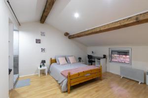 a bedroom with a bed in a room with white walls at Cabana & Maison de la Bourbre - Proche Hypercentre in Bourgoin
