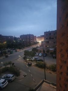 a city street with cars parked in a parking lot at Aprt 4 Family in Marrakech