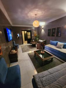 a living room with a couch and a table at Aprt 4 Family in Marrakech