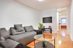 a living room with a couch and a table at Golden Cross // Typical old Quebec appartement in Quebec City