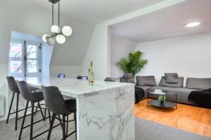 a kitchen and living room with a marble counter top at Golden Cross // Typical old Quebec appartement in Quebec City