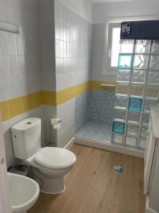 a bathroom with a toilet and a shower at La Perla del Mar in Estepona