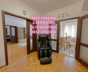 a black chair sitting in the middle of a living room at Relax Old Town Apartment in Oradea