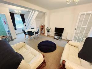 a living room with a couch and a table at City Of Chester Award Winning Cottage -Pixie Terrace Chester in Chester