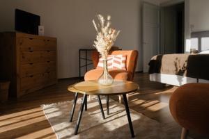 a living room with a vase of flowers on a table at Hotel Splendide in Champex +50 photos