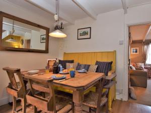 a dining room with a wooden table and chairs at 2 Bed in Polruan PC042 in Fowey