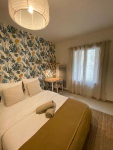 Dormitorio con cama grande y pared de flores en Joli studio centre historique et au calme (2), en Montpellier