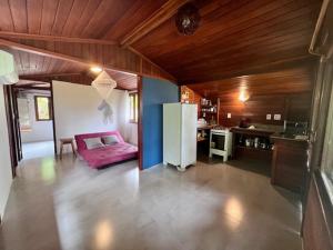 a kitchen with a refrigerator in the middle of a room at Casa do João in Ilha de Boipeba