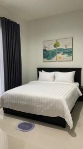 a bedroom with a large bed with white sheets and pillows at i Two Panorama Villas in Batu +15 photos