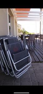 a stack of chairs sitting on a patio at Hotel Vista La Floresta in La Floresta