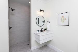 a bathroom with a sink and a mirror at Newcastle 106 Inn at Old Beach in Virginia Beach +26 photos