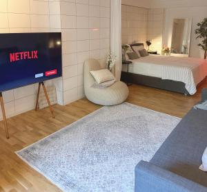 a bedroom with a bed and a tv in a room at Stylish & Cozy Studio in Igoumenitsa