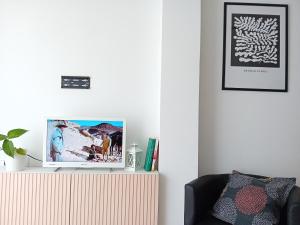 a living room with a tv on top of a cabinet at La viajera Espadan in Algimia de Almonacid