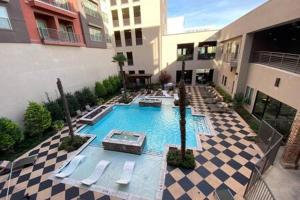 a swimming pool in a courtyard in a building at KING BEDS & Patio-65 inch Roku-Walk to Food and Drinks in Fort Worth
