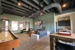 a large living room with a couch and a table at KING BEDS & Patio-65 inch Roku-Walk to Food and Drinks in Fort Worth