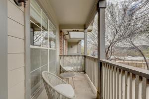 a balcony with two chairs and a window at Landing Modern Apartment with Amazing Amenities (ID2657X93) in Grapevine