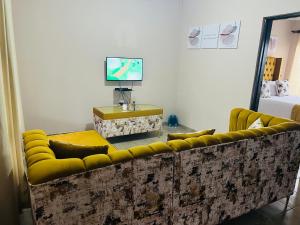 a living room with a couch and a tv at Winbert Apartments in Ladysmith