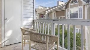 a balcony with two chairs and a house at Landing Modern Apartment with Amazing Amenities (ID3802X2) in Atlanta