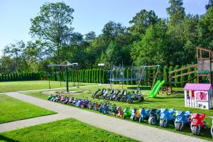 a row of bikes lined up in a park at Ośrodek Wypoczynkowy IDA in Mielenko