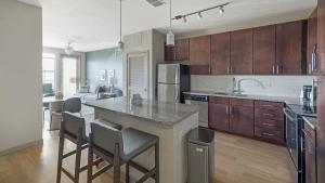 a kitchen with a island in the middle of a room at Landing Modern Apartment with Amazing Amenities (ID4310X3) in Orlando