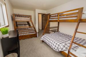 a bedroom with two bunk beds and a desk at Cabin 6 at Horse Creek Resort in Rapid City