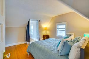 a bedroom with a bed with blue pillows at Pet-Friendly Minneapolis Apartment Near Downtown! in Minneapolis