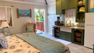 a kitchen with a large bed in a room at The Beach House at Si Como No Inn in Flagler Beach